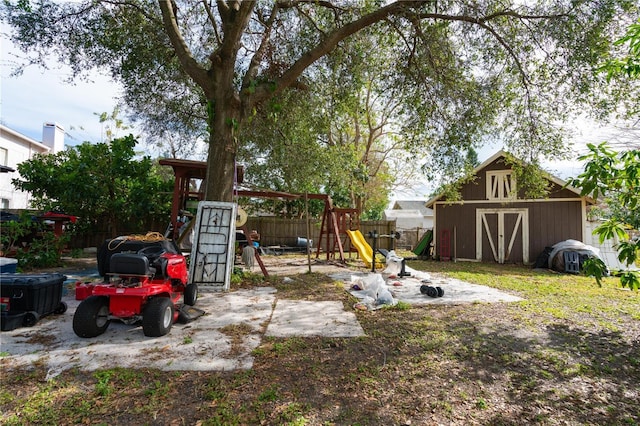 view of yard featuring a playground and a shed