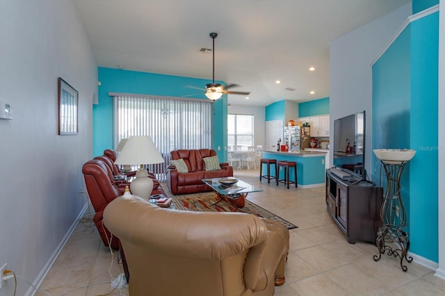 living room with light tile patterned flooring and ceiling fan