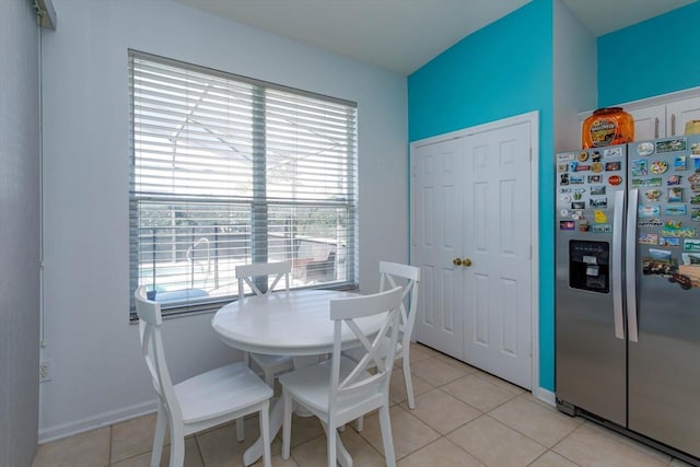 dining area with a wealth of natural light and light tile patterned floors