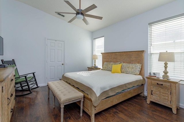 bedroom featuring dark hardwood / wood-style flooring, vaulted ceiling, and ceiling fan