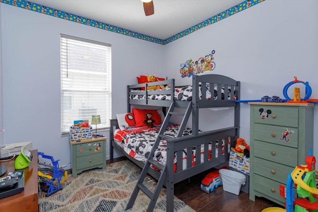 bedroom with ceiling fan, wood-type flooring, and multiple windows