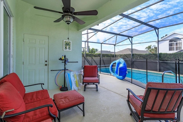 view of pool featuring a mountain view, a patio area, ceiling fan, and glass enclosure