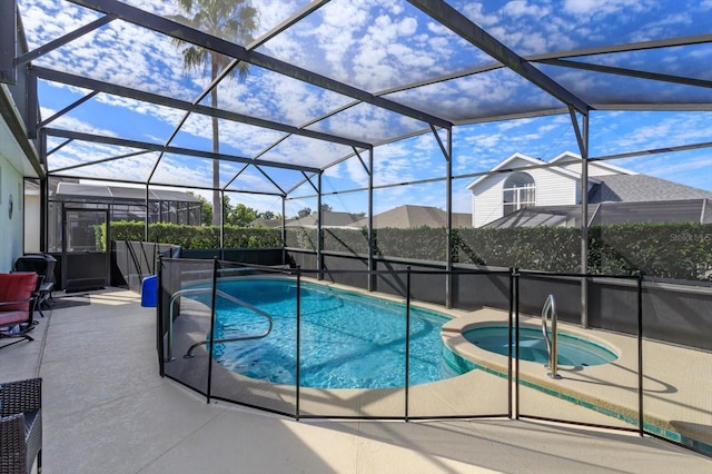 view of swimming pool featuring a patio area, glass enclosure, and an in ground hot tub