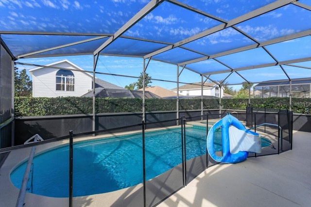 view of pool featuring a patio area and glass enclosure