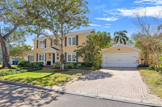 view of front of property featuring a garage and a front lawn