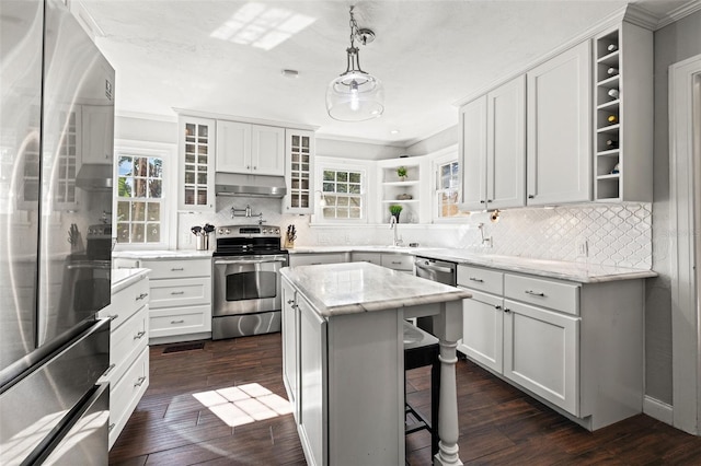 kitchen featuring white cabinetry, stainless steel appliances, and a kitchen island