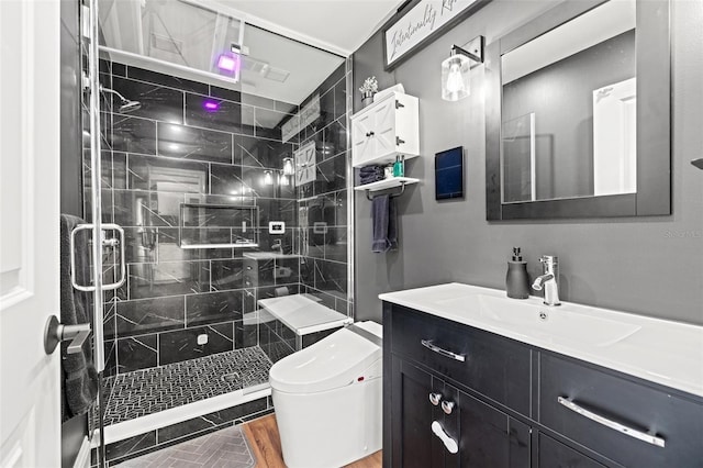 bathroom with vanity, toilet, a shower with shower door, and wood-type flooring