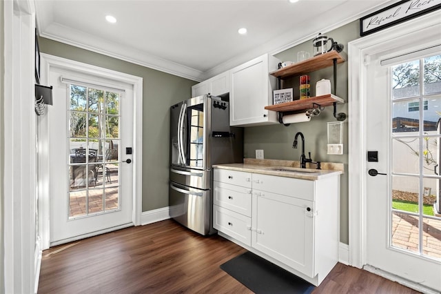 kitchen featuring sink, crown molding, stainless steel refrigerator, dark hardwood / wood-style floors, and white cabinets