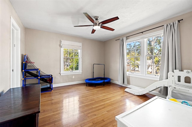 interior space with ceiling fan and wood-type flooring