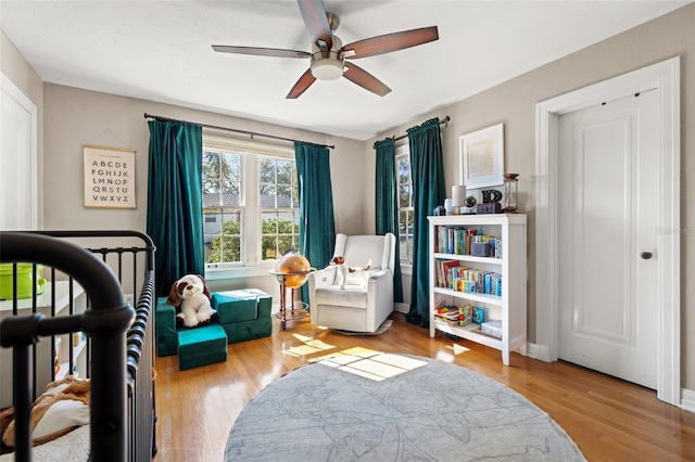 bedroom featuring ceiling fan and light hardwood / wood-style floors