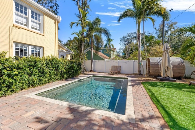 view of swimming pool featuring a storage unit