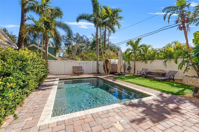 view of swimming pool featuring a yard