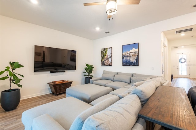 living room featuring ceiling fan and hardwood / wood-style floors