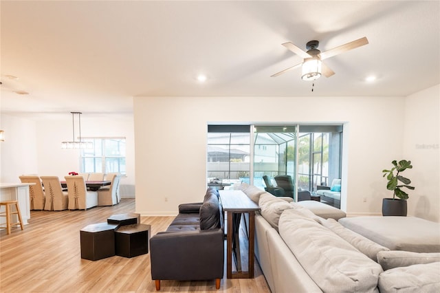 living room featuring ceiling fan and light wood-type flooring