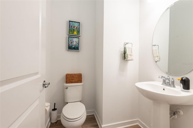 bathroom with wood-type flooring and toilet