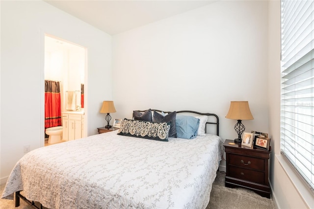 carpeted bedroom featuring ensuite bathroom