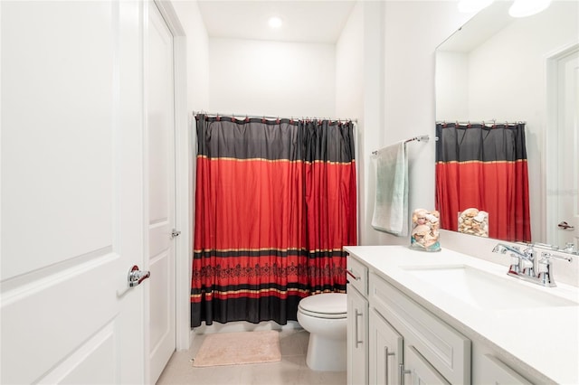 bathroom featuring tile patterned flooring, vanity, and toilet