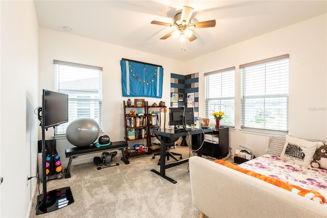 carpeted office space with ceiling fan