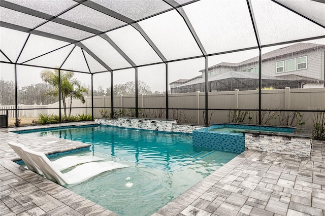 view of pool featuring an in ground hot tub, a lanai, and a patio area