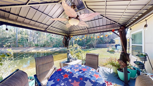 view of patio / terrace with a gazebo, a water view, and ceiling fan