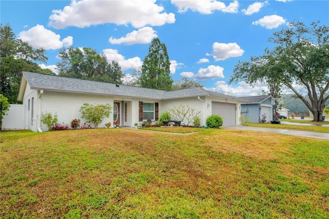 single story home with a garage and a front lawn