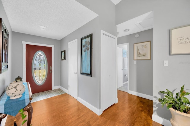 entrance foyer with hardwood / wood-style flooring and a textured ceiling