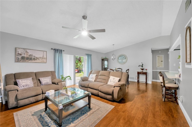 living room featuring lofted ceiling, hardwood / wood-style floors, and ceiling fan