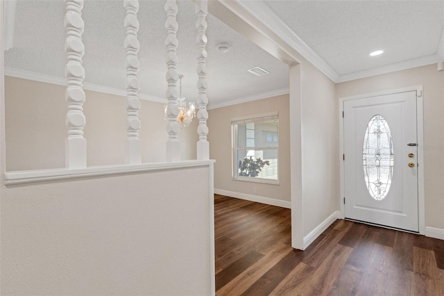 entryway featuring dark wood-type flooring, crown molding, and a textured ceiling