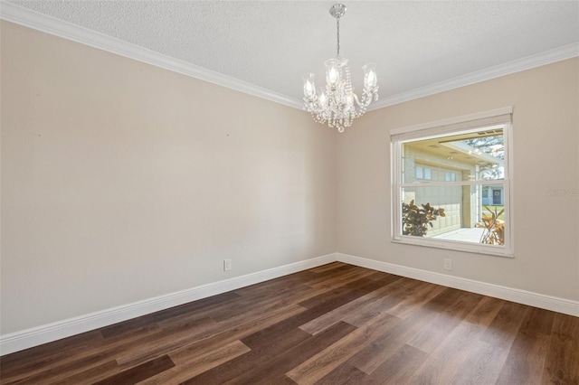 spare room featuring a notable chandelier, crown molding, dark wood-type flooring, and a textured ceiling