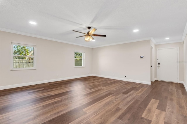 empty room with dark wood-type flooring, ceiling fan, ornamental molding, and a textured ceiling