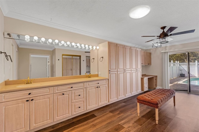 bathroom featuring ceiling fan, ornamental molding, hardwood / wood-style floors, and a textured ceiling