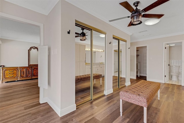 interior space featuring crown molding and hardwood / wood-style floors