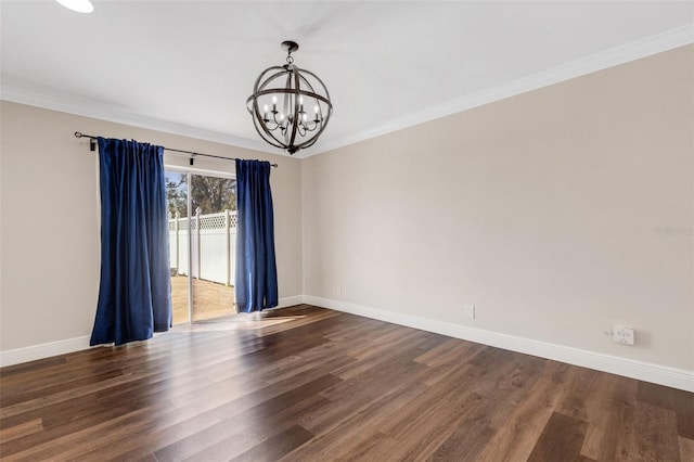 empty room featuring crown molding, dark hardwood / wood-style floors, and a chandelier