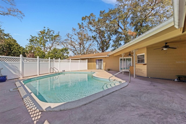 view of swimming pool with ceiling fan and a patio area