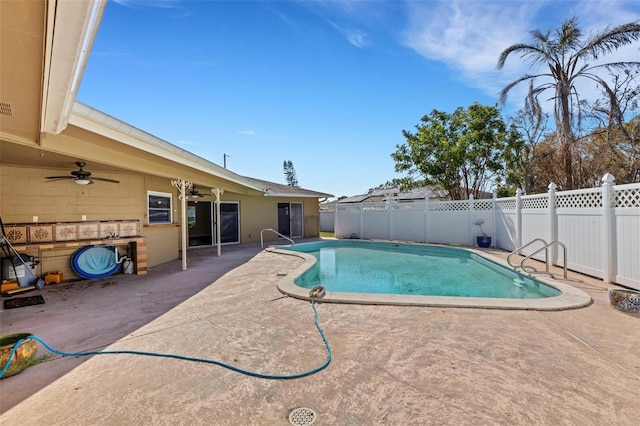 view of pool with a patio area and ceiling fan