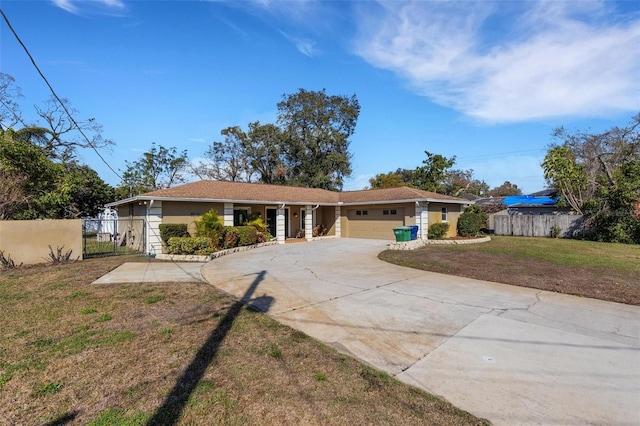 ranch-style house featuring a garage and a front yard