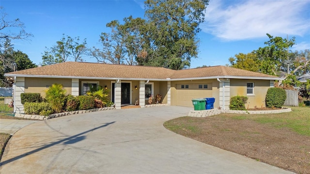 single story home featuring a garage and a front lawn