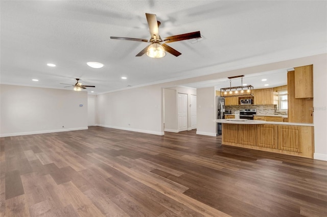 unfurnished living room with sink, a textured ceiling, dark wood-type flooring, and ceiling fan