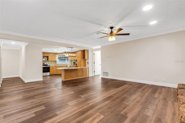 unfurnished living room featuring ornamental molding, dark hardwood / wood-style floors, a textured ceiling, and ceiling fan