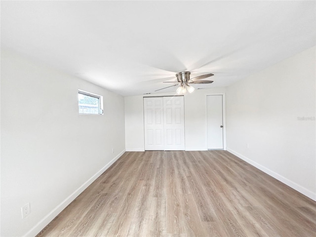 unfurnished bedroom with ceiling fan, a closet, and light hardwood / wood-style flooring