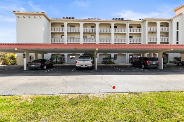 view of building exterior with covered parking