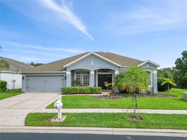 ranch-style home with a garage and a front lawn