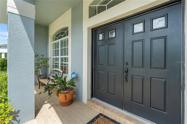 view of exterior entry featuring a porch