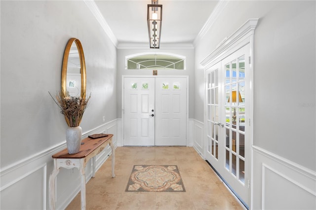 tiled foyer with french doors and ornamental molding