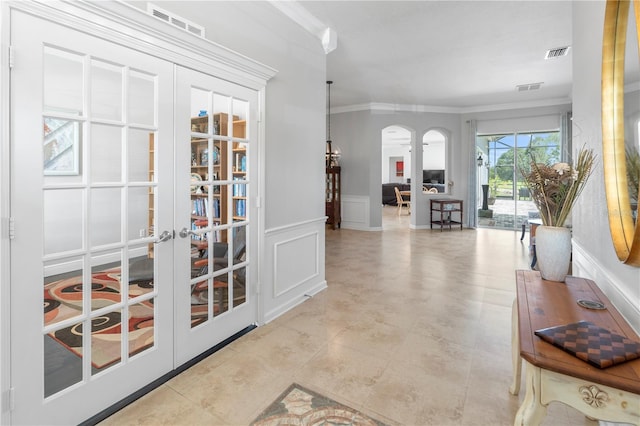 corridor featuring french doors and ornamental molding