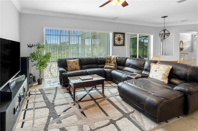 living room featuring ceiling fan and ornamental molding