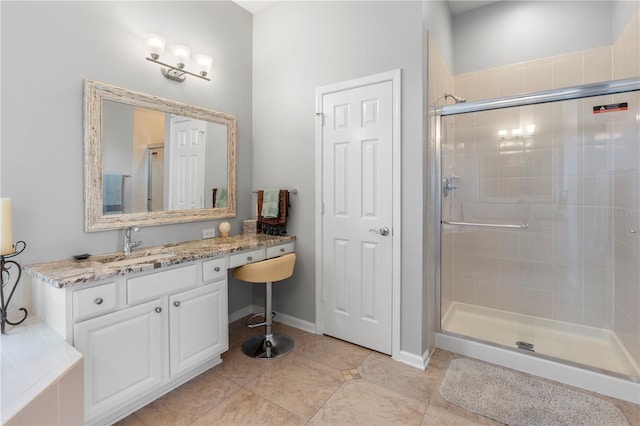 bathroom featuring an enclosed shower, vanity, and tile patterned flooring