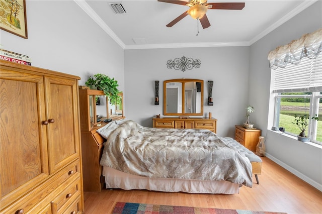 bedroom featuring crown molding, ceiling fan, and light hardwood / wood-style flooring