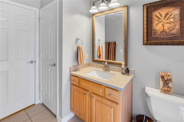 bathroom with vanity, tile patterned floors, and toilet