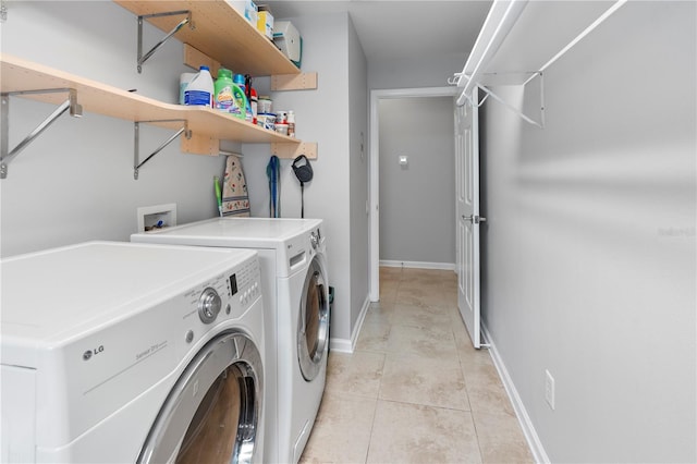 laundry room with light tile patterned flooring and washing machine and dryer